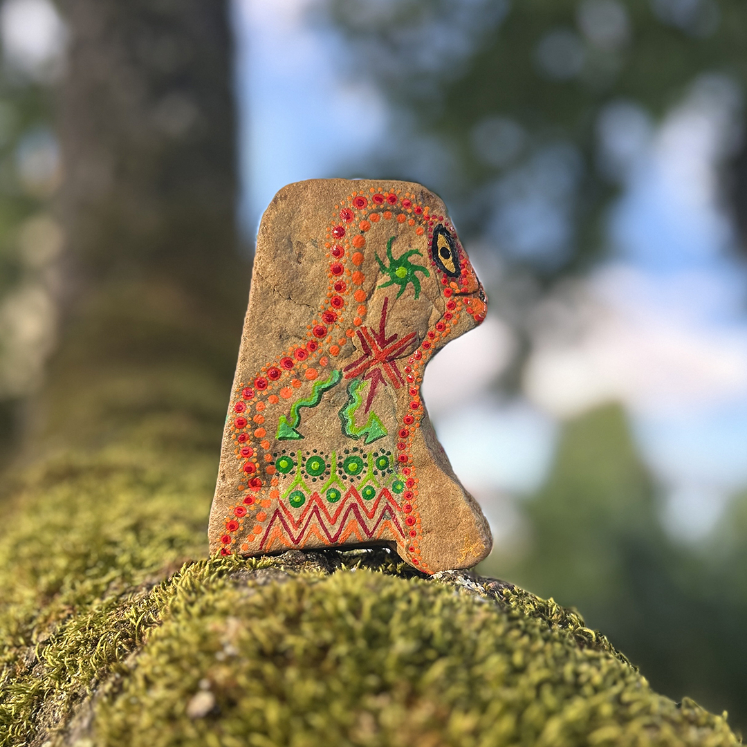 Indianischer Vogel auf einem Stein in Acrylfarbe gestaltet auf Ast