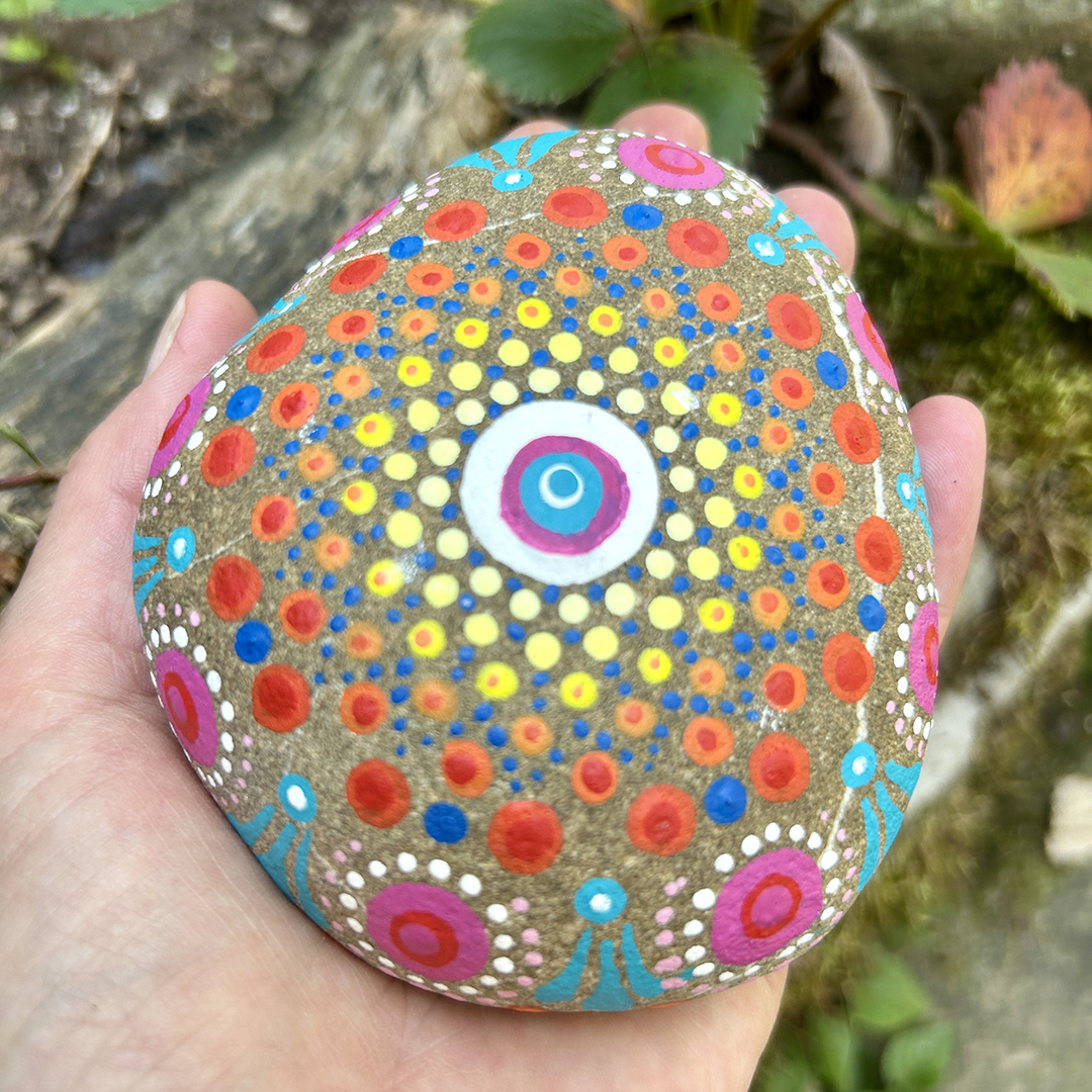 Bemalter Stein mit Mandala auf der Hand