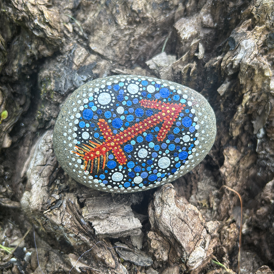 Bemalter Stein mit astrologischem Symbol Schütze